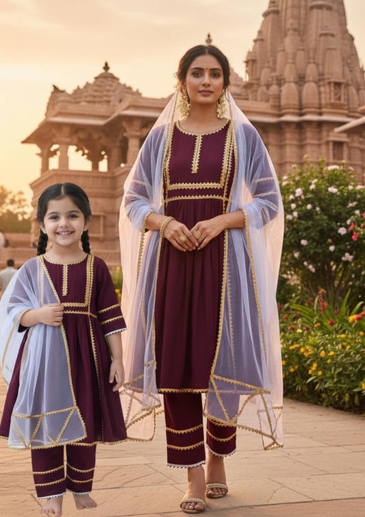 Mother and daughter wearing matching sets at a temple