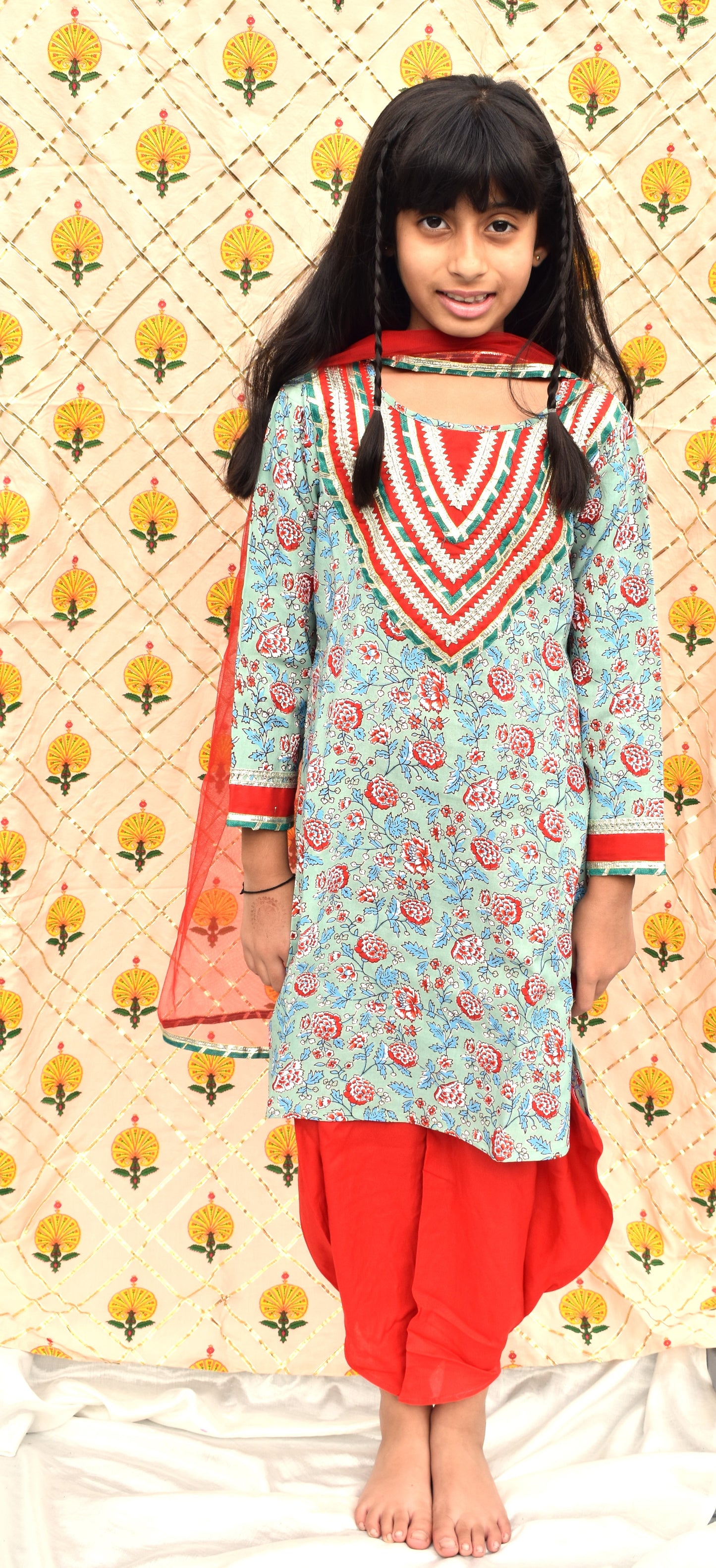 Hara : Green printed kurta with red dhoti and dupatta