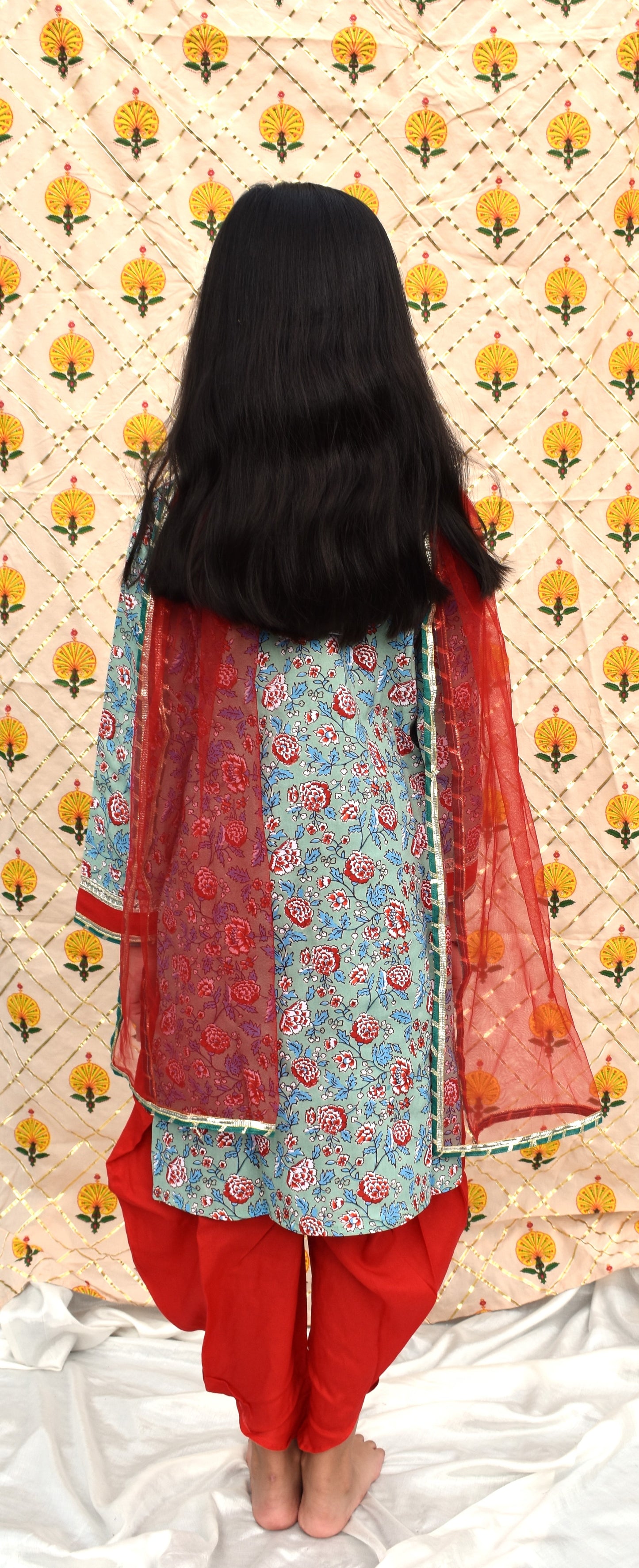 Hara : Green printed kurta with red dhoti and dupatta