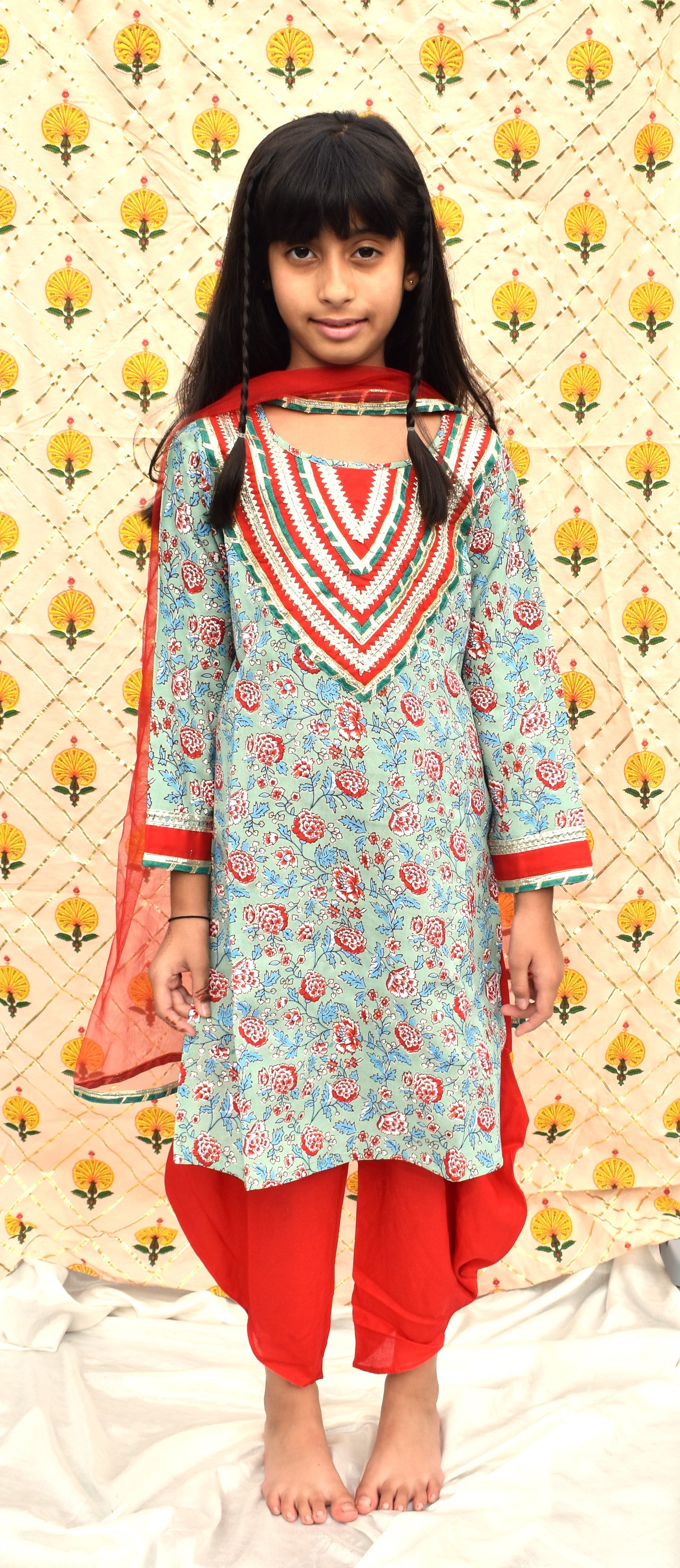 Hara : Green printed kurta with red dhoti and dupatta